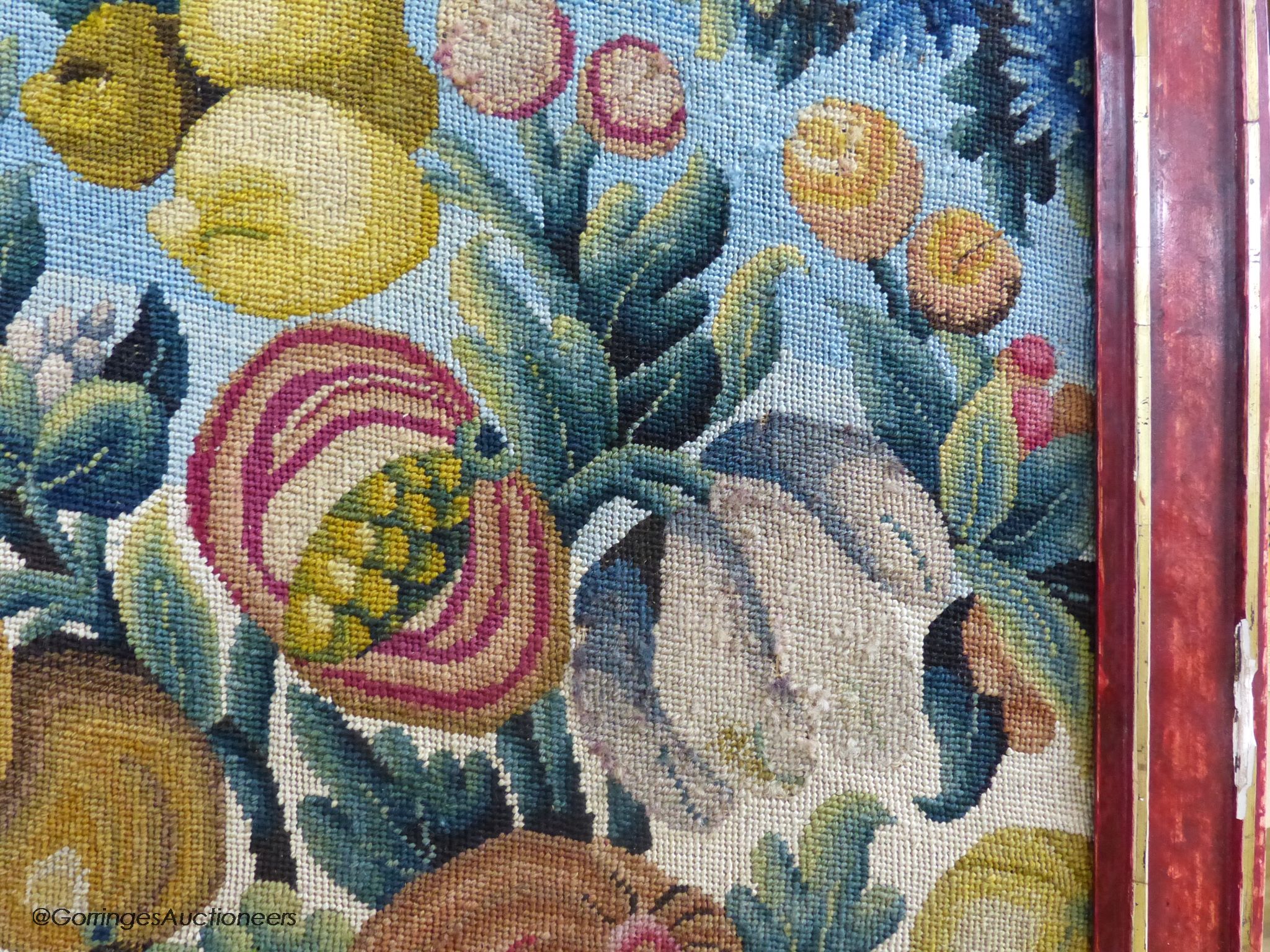 A framed 19th century woolwork panel depicting pomegranates, other fruit and flowers, 71 x 38cm